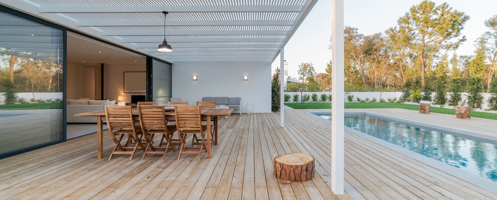 Shadrick Construction Renovated home with a pool and wooden deck.